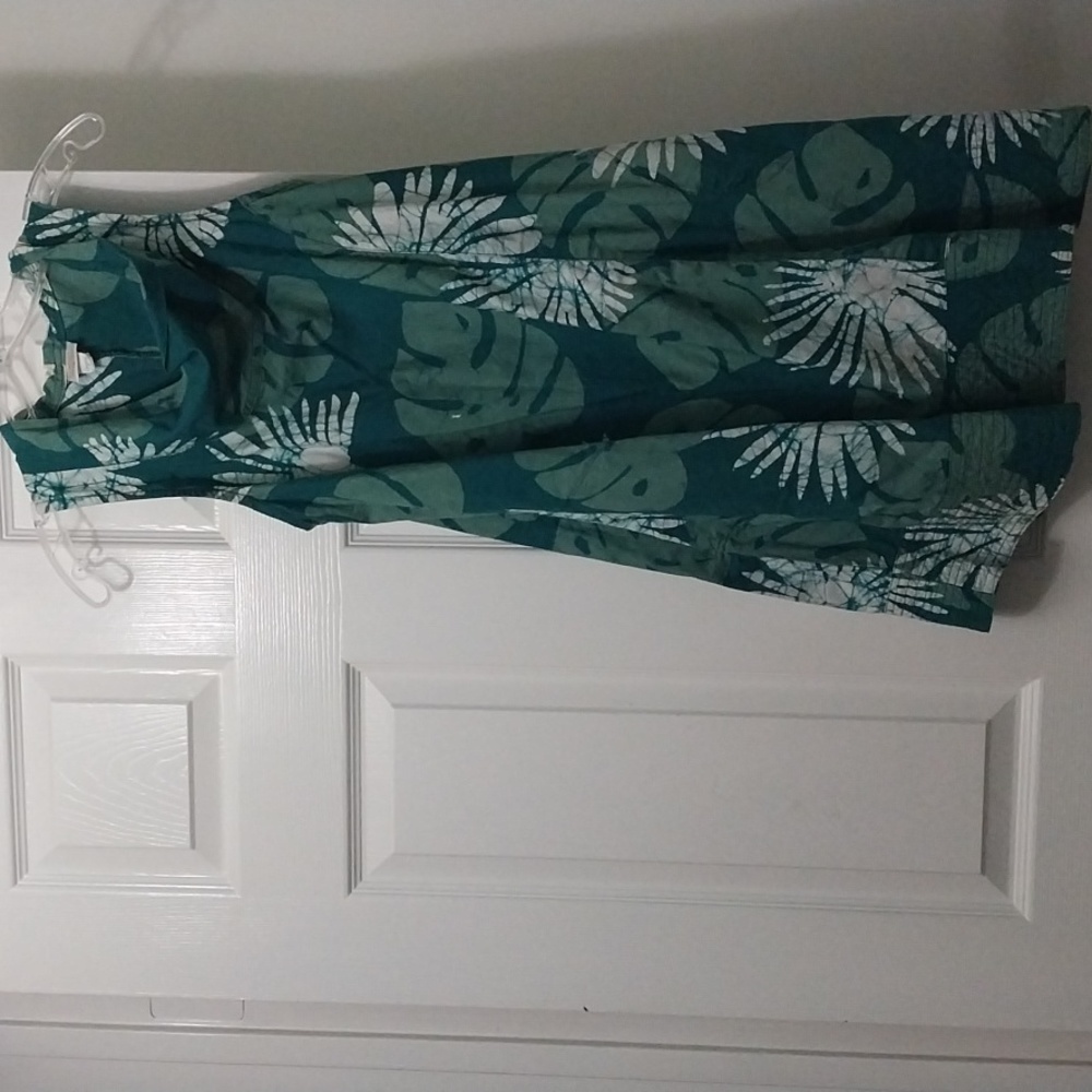 A small Global mamas dress green with Leaf patterns